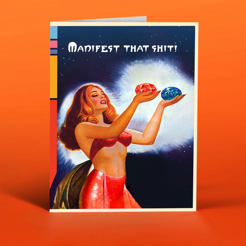 Vintage pulp style outline of a woman in a red bikini, holding up crystals to the sky. The text is Manifest That Shit. This is a greeting card. Orange and Blue's. 